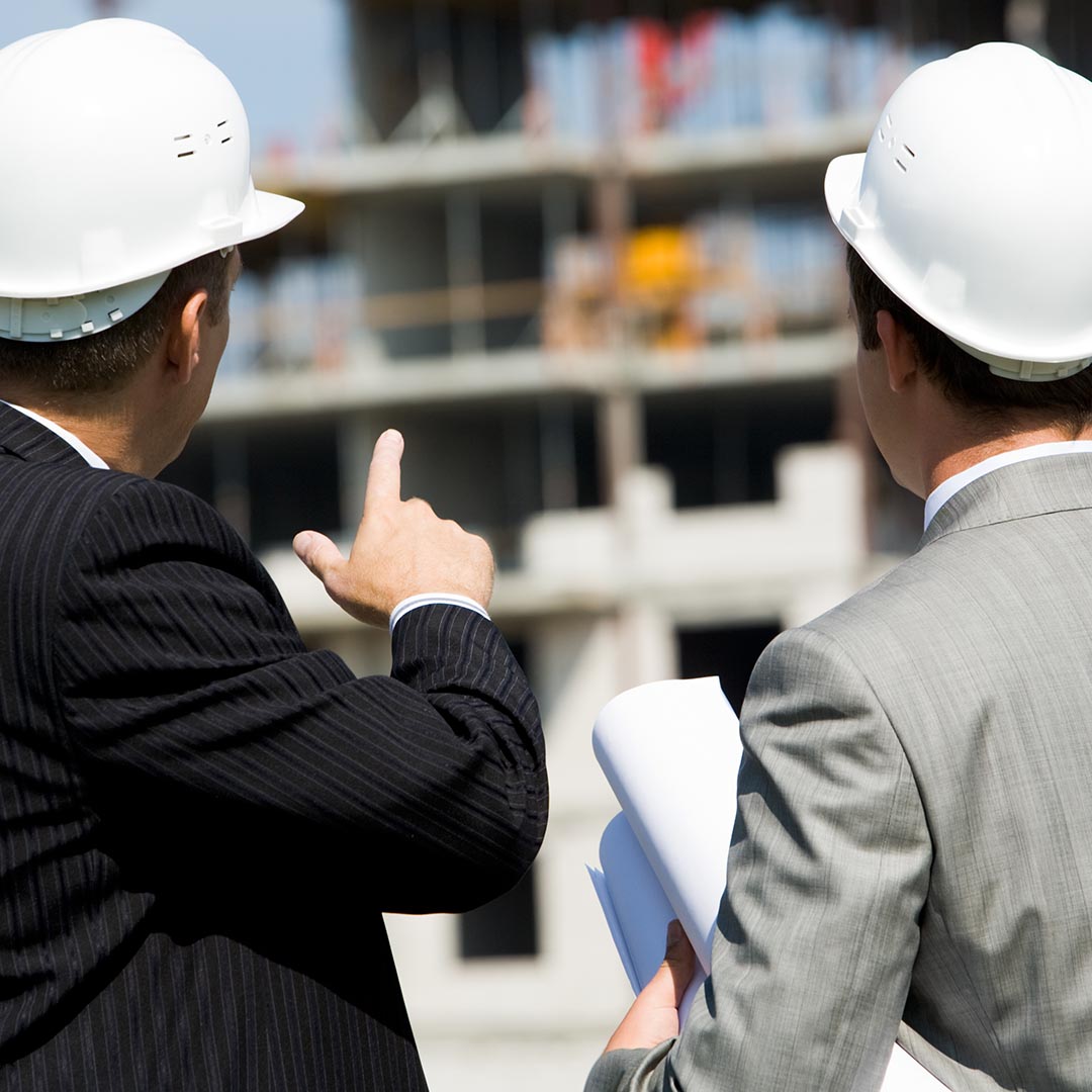 Two engineers looking at a building structure